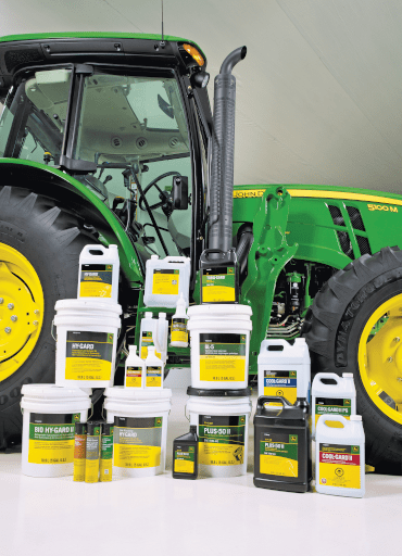 John Deere oil and fluids in front of a tractor
