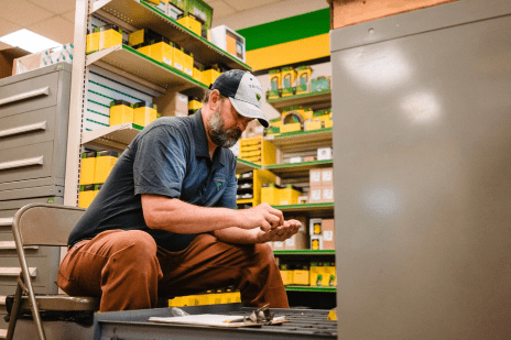 A John Deere parts person finds parts in a TriGreen dealership