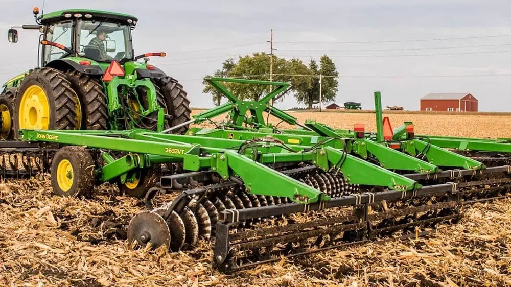 A John Deere 2633 vertical tillage tool working in a farm field