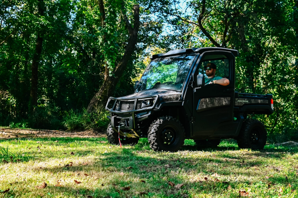 John Deere gator in a forested area 