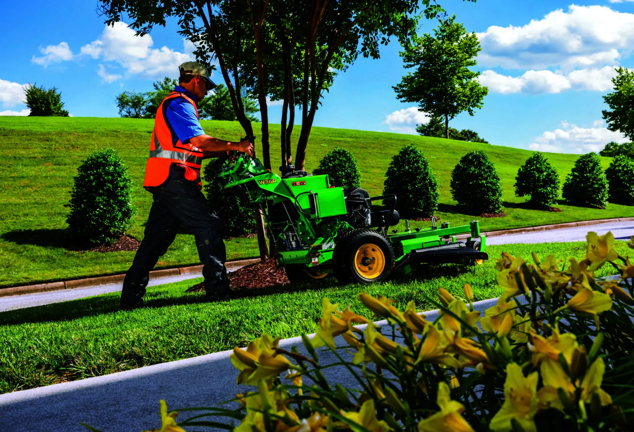 Technician mowing strip of lawn