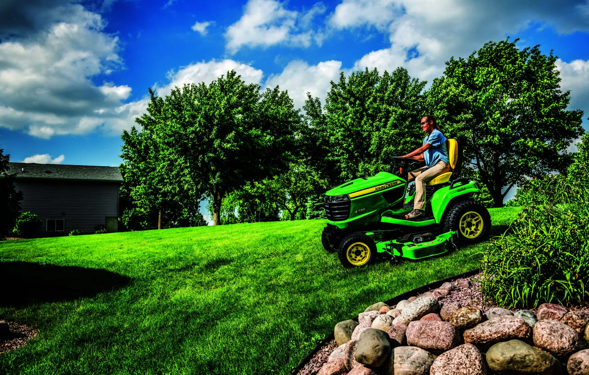 Person cutting lawn with X7 lawn tractor