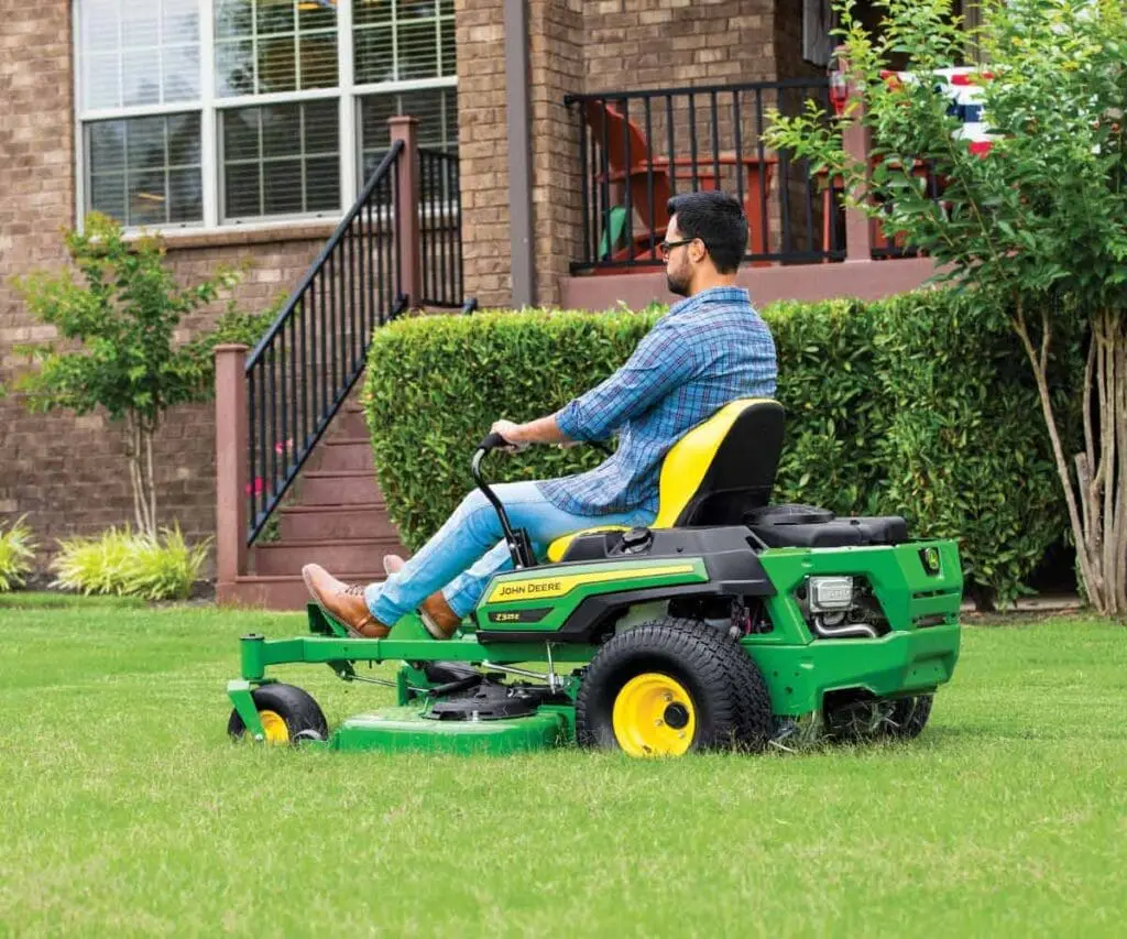 Image of man mowing with Z325E John Deere zero turn mower