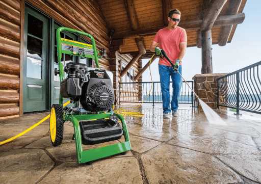 Technician power washing a deck