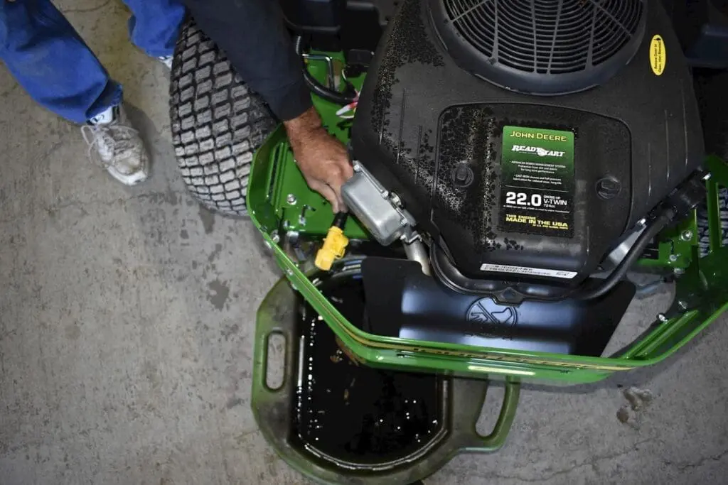 bucket under mower catching the old oil