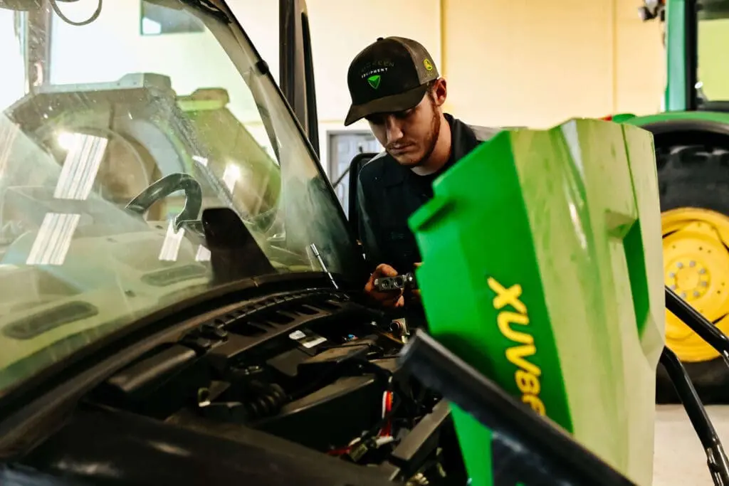 TriGreen service tech works on John Deere Gator side by side.