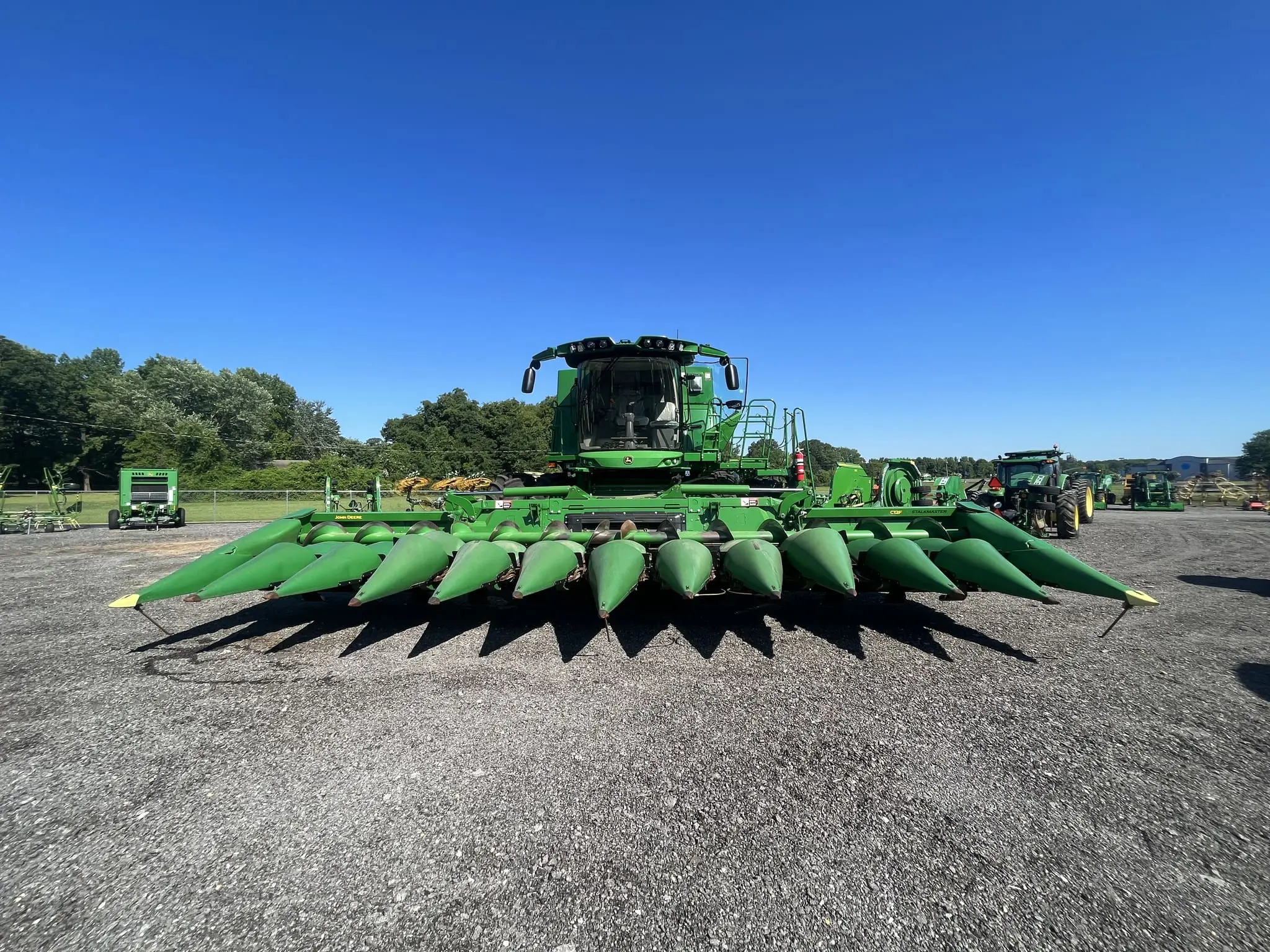 A used John Deere combine on a TriGreen dealership lot
