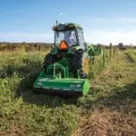 A John Deere 5075R tills a field