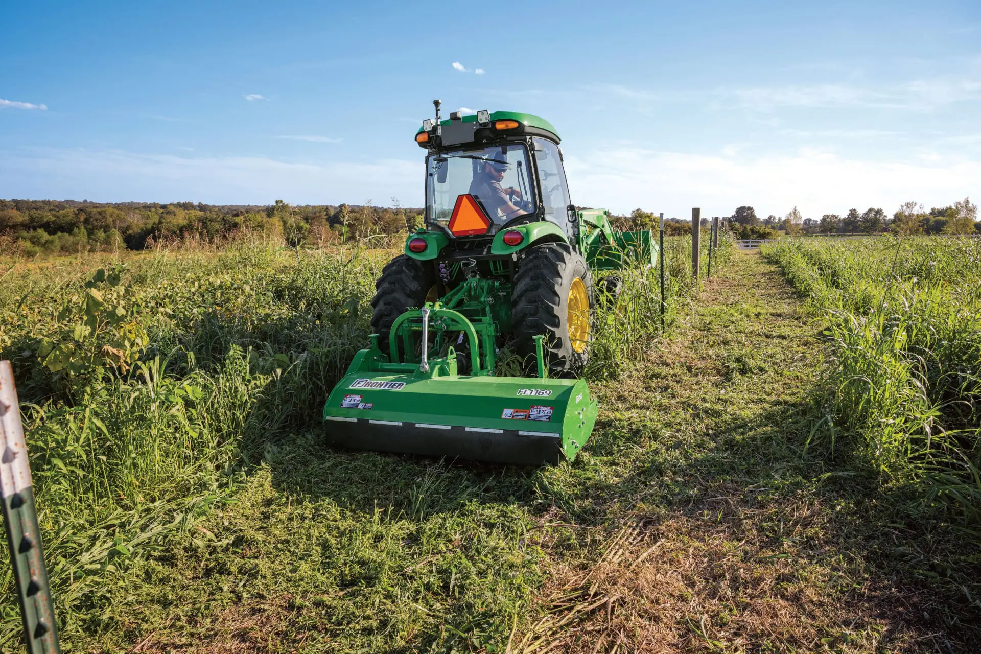 A John Deere 5075R tills a field