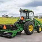 A John Deere 5075R tractor parked on a farm