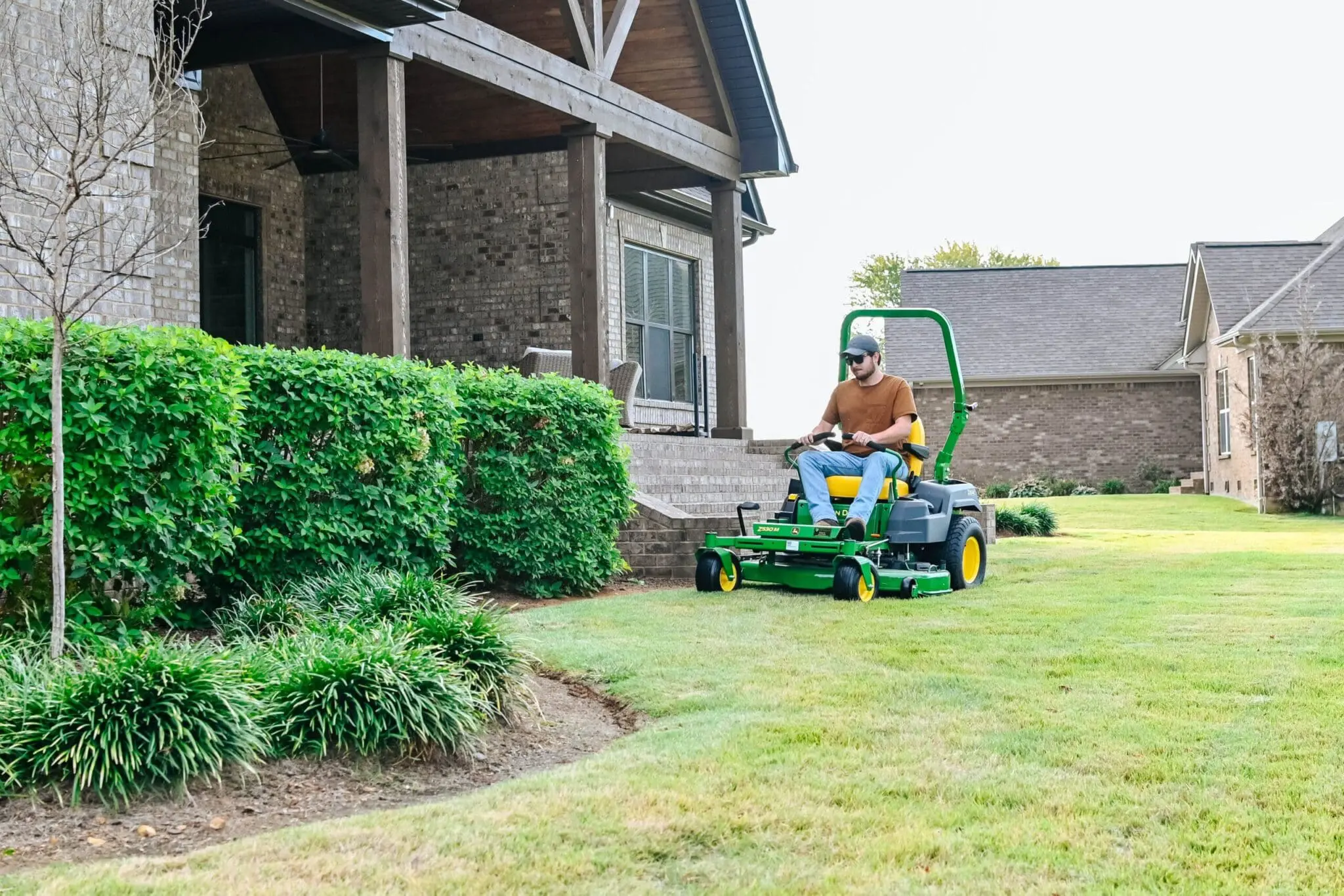 Man using z500 mower to mow a yard