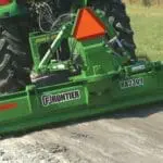 Frontier RB2309 leveling sand on back of John Deere compact tractor