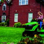 A woman mows with an S110 lawn mower