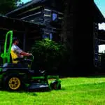 A man mows near a cabin with a Z740R mower