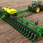 John Deere row crop tractor pulling John Deere planter