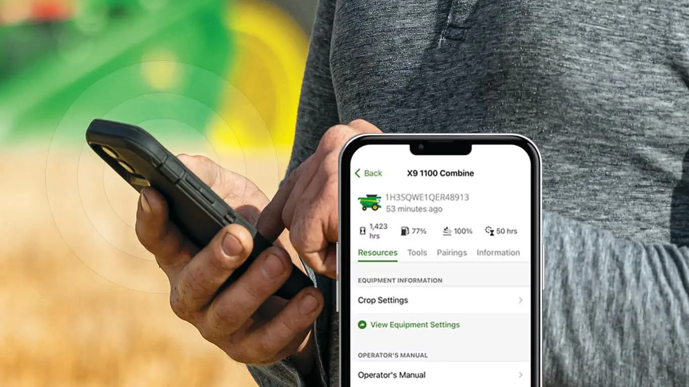 Man uses John Deere Equipment Mobile App in field