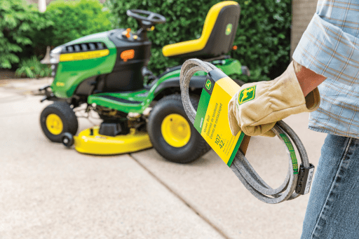 A person installs a John Deere belt on a X350 mower