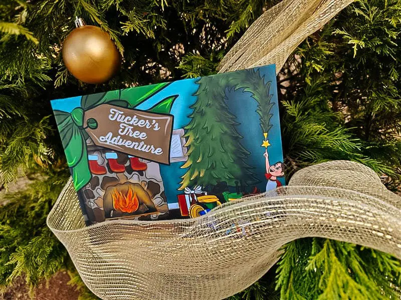 Hardcover copy of Tucker's Tree Adventure in a Christmas tree