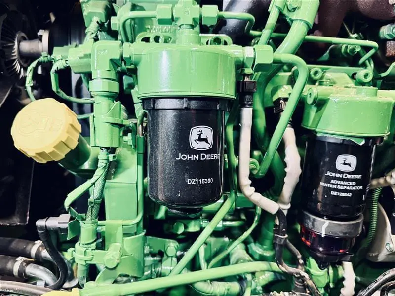 Image of John Deere utility tractor engine oil cap, oil filter and fuel filter.