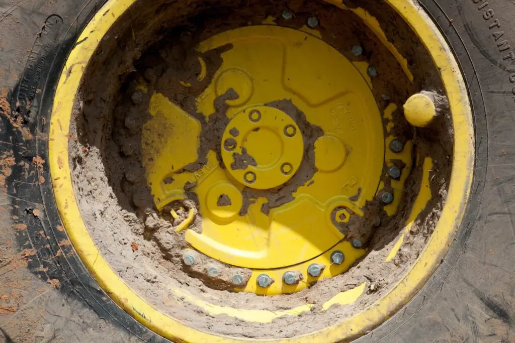 Muddy John Deere tire and wheel