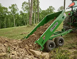 Frontier HT5015 hydraulic dump trailer dumps dirt into pile.