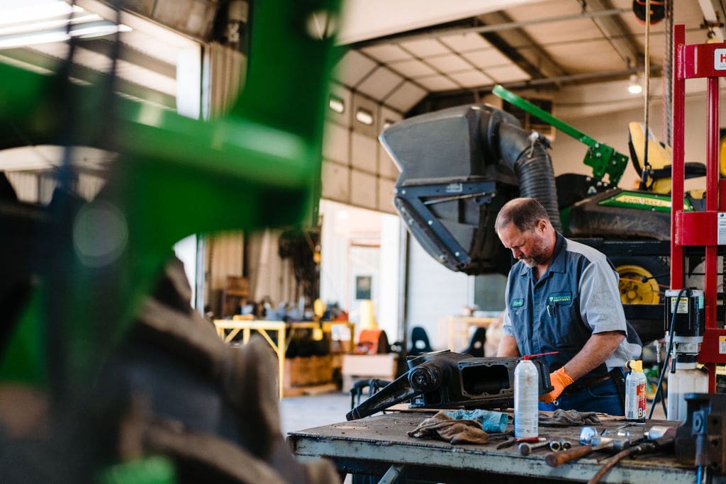 Technician working on tractor part