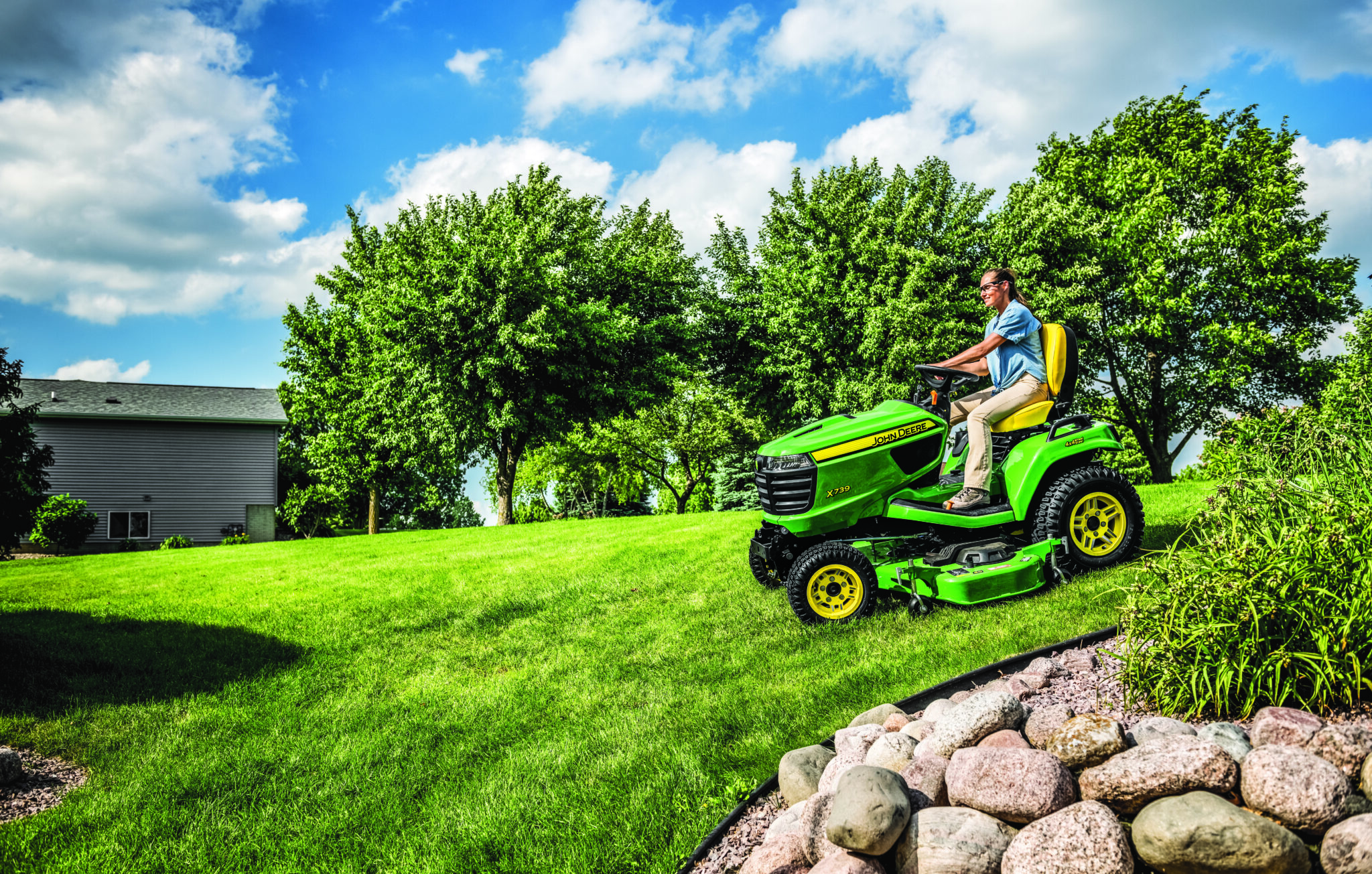 Person cutting lawn with X7 lawn tractor