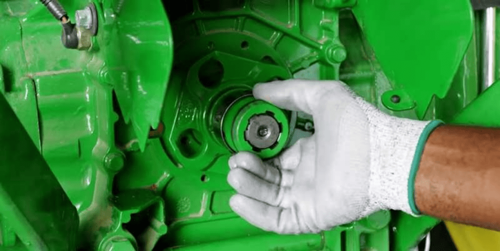 Technician adjusting tractor part
