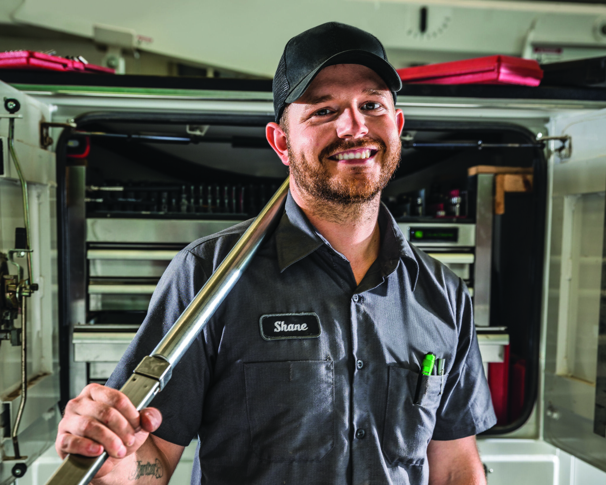 Smiling technician at a John Deere dealership