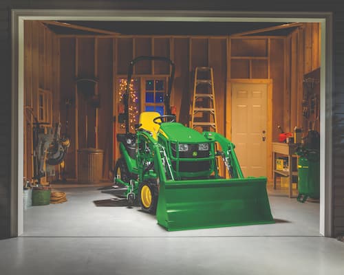 John Deere Compact tractor with shovel attachment