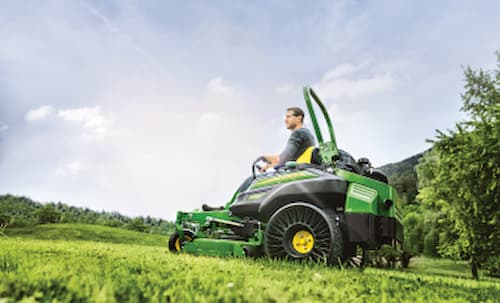 Technician operating a ztrak mower 
