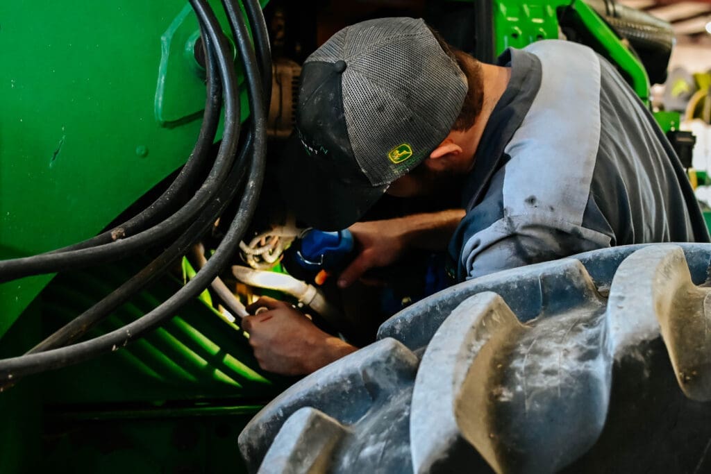 TriGreen technician works on John Deere equipment