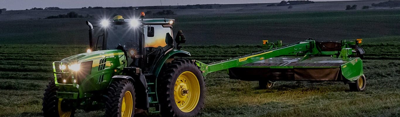 Large Tractor with attachment being used to till the land