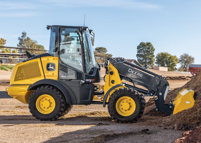 A John Deere 326P wheel loader lifts a load of dirt