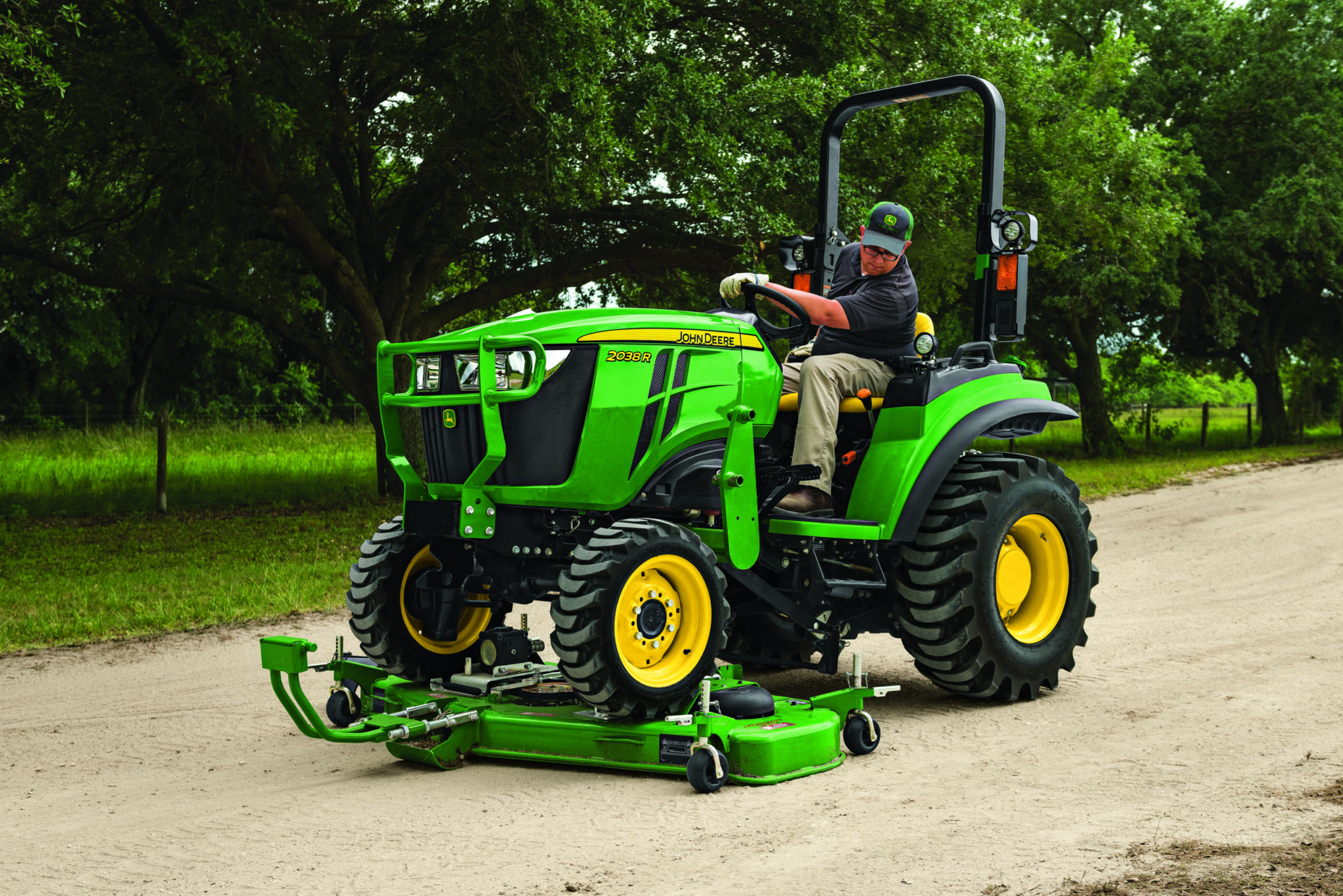 A person drives over the AutoConnect mower deck with a 2R tractor
