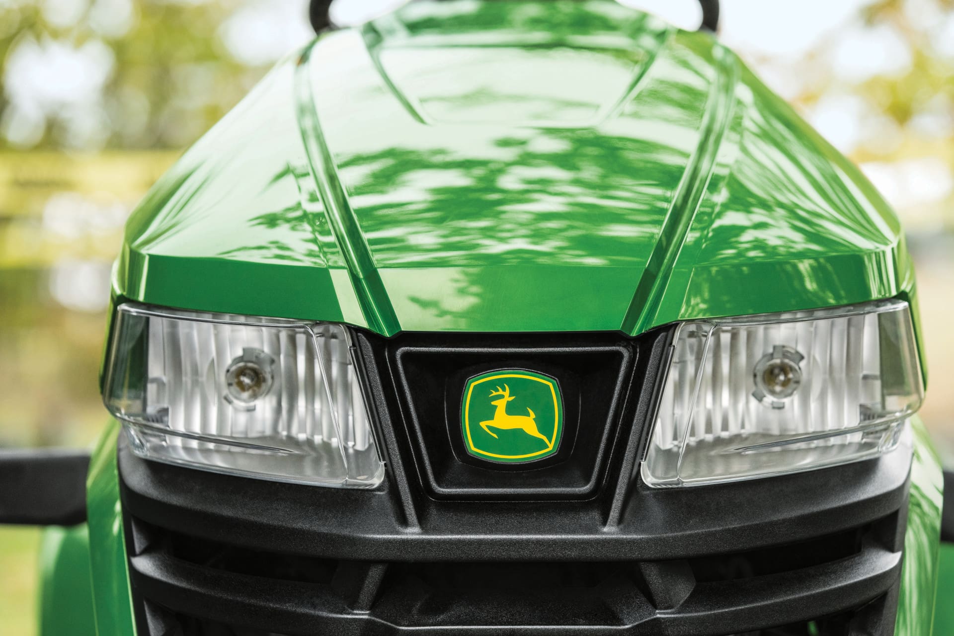 An up-close shot of the hood and John Deere logo on an X3 lawn tractor
