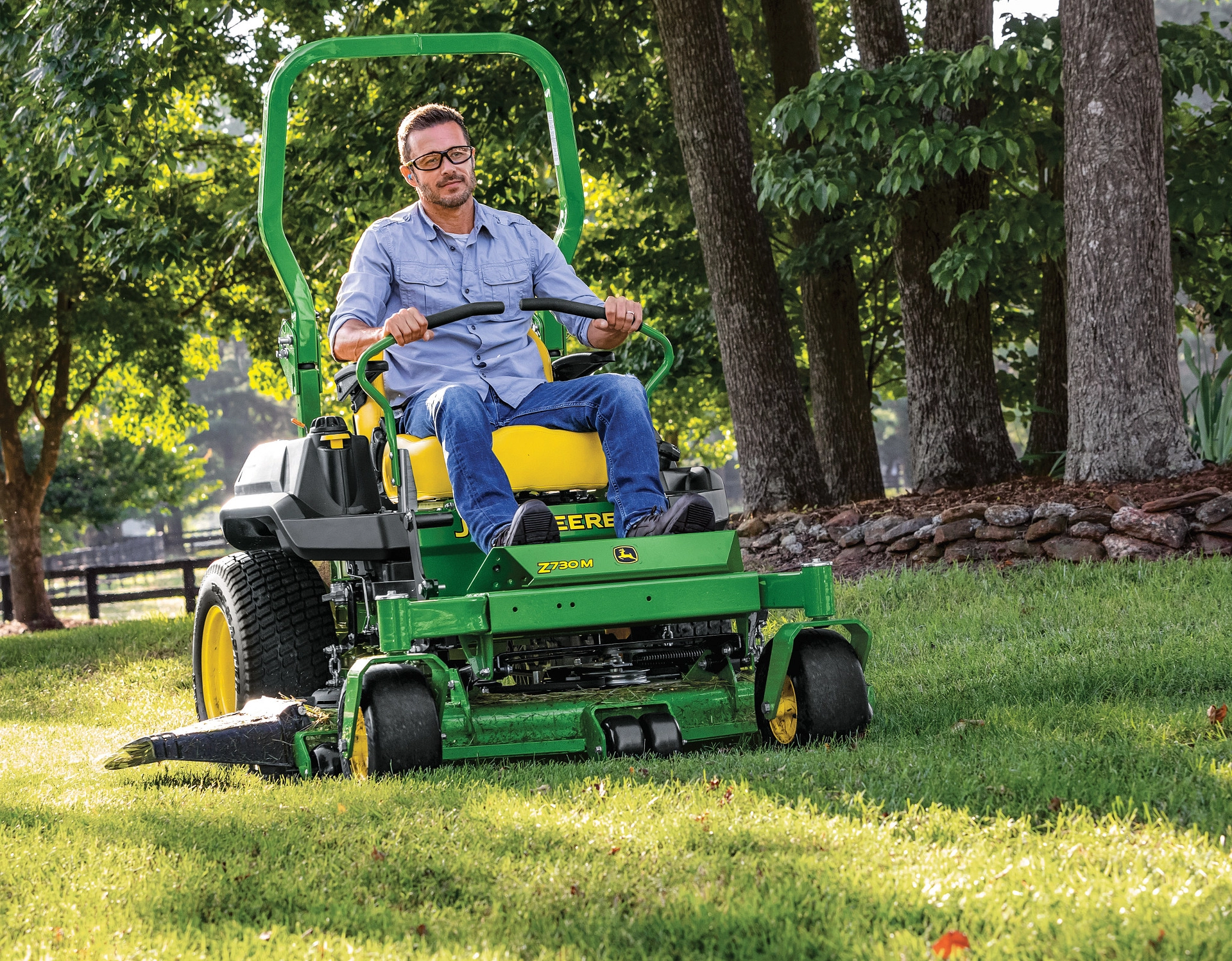 Man mows lawn with John Deere Z730M ZTrak zero turn mower