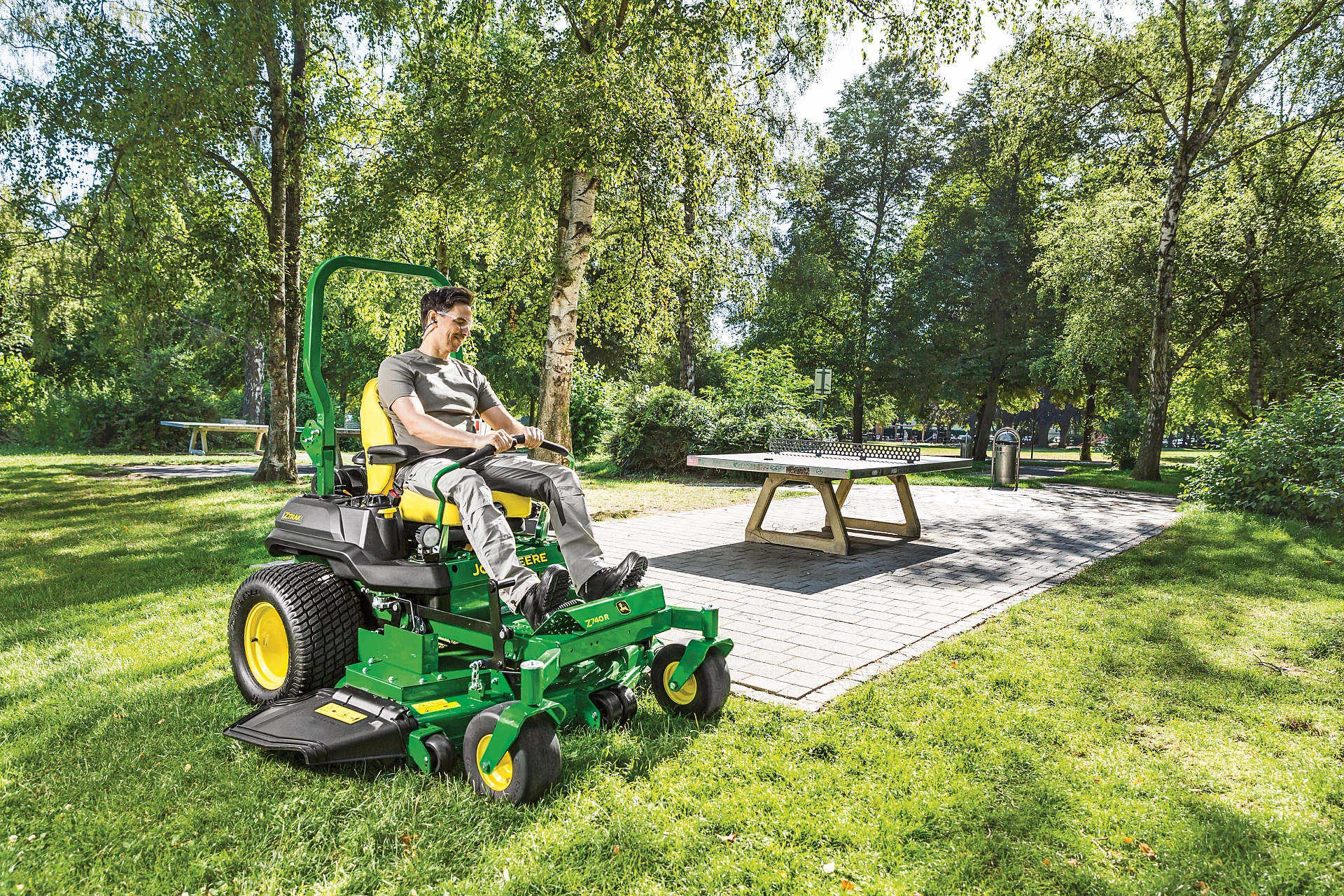 Man mows around picnic area with John Deere Z740R ZTrak zero turn mower