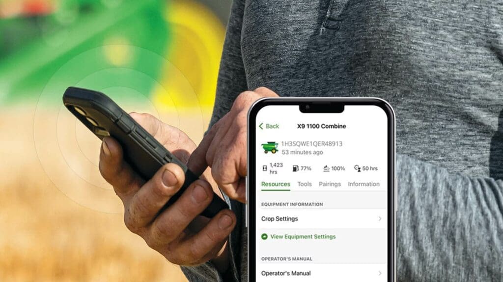Man uses John Deere Equipment Mobile App in field