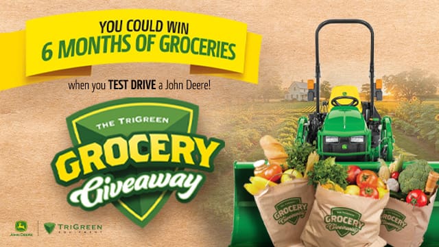 TriGreen Grocery Giveaway Shield, yellow banner that reads "6 months of free groceries" and John Deere compact tractor with grocery bags in loader bucket